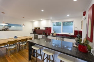 white-gloss-vinyl-spotted gum-polished floors-vanilla noir-kitchen-update-blood pearl-splashback-white pendants-breakfast bar